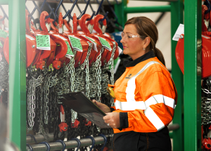 Sunbelt Rentals employee in front of lifting equipment